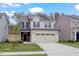 Inviting two-story home with lush green lawn and convenient two-car garage at 2007 Seford Dr, Durham, NC 27703