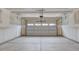 Spacious two car garage featuring concrete flooring and white door with automatic opener at 2007 Seford Dr, Durham, NC 27703