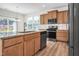 Open kitchen features an island, granite countertops, stainless appliances, and light wood cabinets at 2007 Seford Dr, Durham, NC 27703