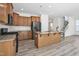 Open kitchen features an island, granite countertops, stainless appliances, and light wood cabinets at 2007 Seford Dr, Durham, NC 27703