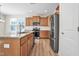 Open kitchen features an island, granite countertops, stainless appliances, and light wood cabinets at 2007 Seford Dr, Durham, NC 27703