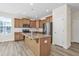 Open kitchen features an island, granite countertops, stainless appliances, and light wood cabinets at 2007 Seford Dr, Durham, NC 27703