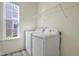 Bright laundry room featuring a window and shelving above the included washer and dryer at 2007 Seford Dr, Durham, NC 27703