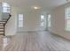 Open living room with a staircase and large windows allowing for plenty of natural light at 2007 Seford Dr, Durham, NC 27703