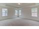 Spacious main bedroom with tray ceiling and multiple windows at 2007 Seford Dr, Durham, NC 27703