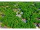 Aerial view shows the Treyburn Country Club tennis courts surrounded by vibrant trees and lush landscaping at 201 Johnstone Ct Ct, Durham, NC 27712