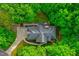 Aerial view of a home nestled in lush greenery with a brick patio and well-manicured landscaping at 201 Johnstone Ct Ct, Durham, NC 27712