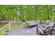 A comfortable deck with outdoor seating overlooking a lush green yard at 201 Johnstone Ct Ct, Durham, NC 27712