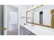 Bathroom with gray vanity, ample mirror, and a view to a nearby bedroom at 201 Johnstone Ct Ct, Durham, NC 27712