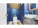 Modern powder room featuring blue walls, wood ceiling, vessel sink and unique mirror at 201 Johnstone Ct Ct, Durham, NC 27712