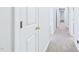 Hallway featuring neutral walls, carpet, and white doors with gold handles at 201 Johnstone Ct Ct, Durham, NC 27712
