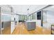 Open kitchen with stainless steel appliances, granite countertops, hardwood floors, and center island at 201 Johnstone Ct Ct, Durham, NC 27712