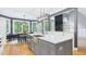Bright kitchen with stainless steel island sink and eat-in dining area overlooking the yard at 201 Johnstone Ct Ct, Durham, NC 27712