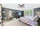 Main bedroom with large window, dark walls, ceiling fan, and an upholstered chair at 201 Johnstone Ct Ct, Durham, NC 27712