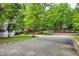 Street view of home with mature trees and landscaping in a friendly neighborhood at 201 Johnstone Ct Ct, Durham, NC 27712