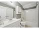 This bathroom features white tile, a toilet, vanity, and shower/tub combo at 2028 Ruddy Rd, Raleigh, NC 27616