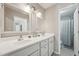 Bright bathroom featuring double sinks with white cabinetry and a shower with curtain at 2028 Ruddy Rd, Raleigh, NC 27616