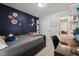 This is a bedroom with a flower mural, desk, and view into the hall at 2028 Ruddy Rd, Raleigh, NC 27616
