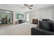 Living room with gray carpet, fireplace, ceiling fan, and a tv near dining area at 2028 Ruddy Rd, Raleigh, NC 27616