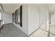 Wide angle view of the covered front porch with vinyl siding, black shutters, and concrete floor at 2028 Ruddy Rd, Raleigh, NC 27616
