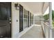 View of the front porch with black door and shutters, digital lock, and outdoor light fixture at 2028 Ruddy Rd, Raleigh, NC 27616
