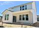 Modern home featuring a bright white siding exterior with large windows and sliding glass doors to the backyard patio at 203 Steel Spring Rd # 21, Angier, NC 27501