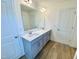 Bathroom vanity with double sinks, white countertop and gray cabinets plus modern finishes at 203 Steel Spring Rd # 21, Angier, NC 27501