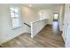 Bright hallway with hardwood floors and natural light coming from the windows on the side at 203 Steel Spring Rd # 21, Angier, NC 27501