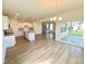Open-concept living space with hardwood floors, island kitchen and large sliding doors to the outside at 203 Steel Spring Rd # 21, Angier, NC 27501