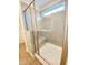 Modern bathroom with a walk-in shower, glass doors and window for natural light at 203 Steel Spring Rd # 21, Angier, NC 27501