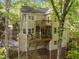 Multi-level deck with screened porch provides beautiful outdoor living space surrounded by lush trees at 205 Glenview Pl, Chapel Hill, NC 27514