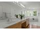 Bright bathroom with double vanity, soaking tub and large mirror at 205 Glenview Pl, Chapel Hill, NC 27514