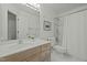 Clean, bright bathroom featuring a shower/tub, vanity with storage, and a large mirror at 205 Glenview Pl, Chapel Hill, NC 27514