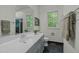 Elegant bathroom featuring a large mirror, modern fixtures, and natural light from the window at 205 Glenview Pl, Chapel Hill, NC 27514