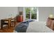 Cozy bedroom features hardwood floors, a comfy bed, and an abundance of natural light at 205 Glenview Pl, Chapel Hill, NC 27514