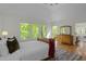Primary bedroom with hardwood floors, ensuite bath and access to a private deck at 205 Glenview Pl, Chapel Hill, NC 27514