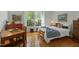 Bright bedroom featuring a comfortable bed, hardwood floors, and great view of the outdoors at 205 Glenview Pl, Chapel Hill, NC 27514