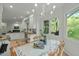Bright dining area featuring light-colored walls, a table with floral motifs, and picturesque views from large windows at 205 Glenview Pl, Chapel Hill, NC 27514
