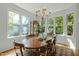 Dining room with a hardwood table, chandelier, and large windows offering great view of the outdoors at 205 Glenview Pl, Chapel Hill, NC 27514