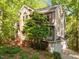 Charming home featuring a mix of brick and siding, set amidst lush trees and a brick walkway leading to the entrance at 205 Glenview Pl, Chapel Hill, NC 27514