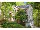 Two-story home featuring brick accents and lush green trees, offering a sense of privacy and seclusion at 205 Glenview Pl, Chapel Hill, NC 27514
