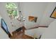 Second story view of the bright foyer with chandelier and hardwood floors at 205 Glenview Pl, Chapel Hill, NC 27514
