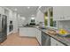 Updated kitchen featuring white cabinets, granite countertops, stainless appliances, and a tile backsplash at 205 Glenview Pl, Chapel Hill, NC 27514