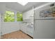 Compact kitchen with white appliances, ample cabinet space, and a view from the window at 205 Glenview Pl, Chapel Hill, NC 27514