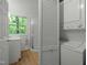 Shot of the laundry area featuring a window, sink, closet and stacked washer and dryer at 205 Glenview Pl, Chapel Hill, NC 27514