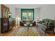 Eclectic living room featuring elegant furnishings, a stylish rug, and ample natural light at 205 Glenview Pl, Chapel Hill, NC 27514