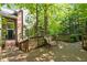 Inviting outdoor deck featuring wood railings, a comfortable bench, and a serene natural setting, ideal for relaxing at 205 Glenview Pl, Chapel Hill, NC 27514
