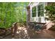 Cozy outdoor patio with a round table and chairs, set against a backdrop of lush green trees and natural beauty at 205 Glenview Pl, Chapel Hill, NC 27514