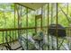 Inviting screened porch with a dining table, perfect for enjoying outdoor meals in a serene setting at 205 Glenview Pl, Chapel Hill, NC 27514