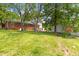 View of the backyard featuring a grassy lawn and partial view of the home at 209 N Occoneechee St, Hillsborough, NC 27278
